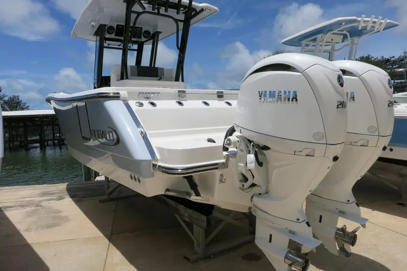 Slide: The Image of 2026 Robalo R270 Center Console boat with twin Yamaha engines docked. - 6