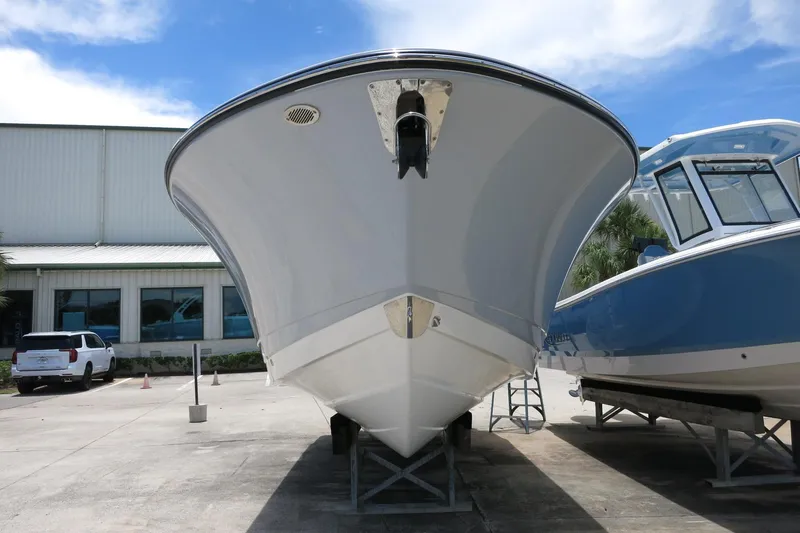 Slide: The Image of 2026 Robalo R270 Center Console boat on display at a marina. - 39