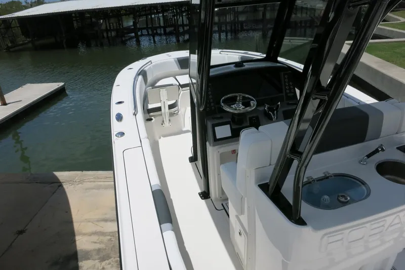Slide: The Image of 2026 Robalo R270 Center Console boat docked, showcasing sleek design and modern features. - 16