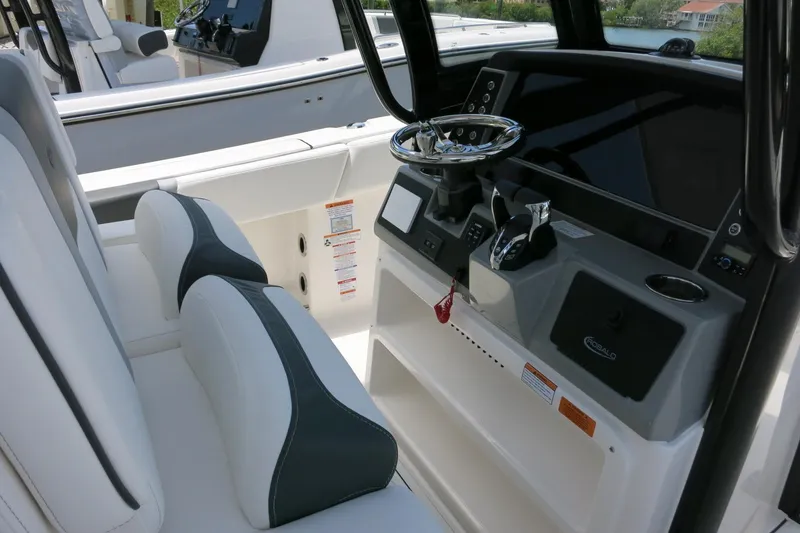 Slide: The Image of 2026 Robalo R270 Center Console boat interior with modern steering and controls. - 19