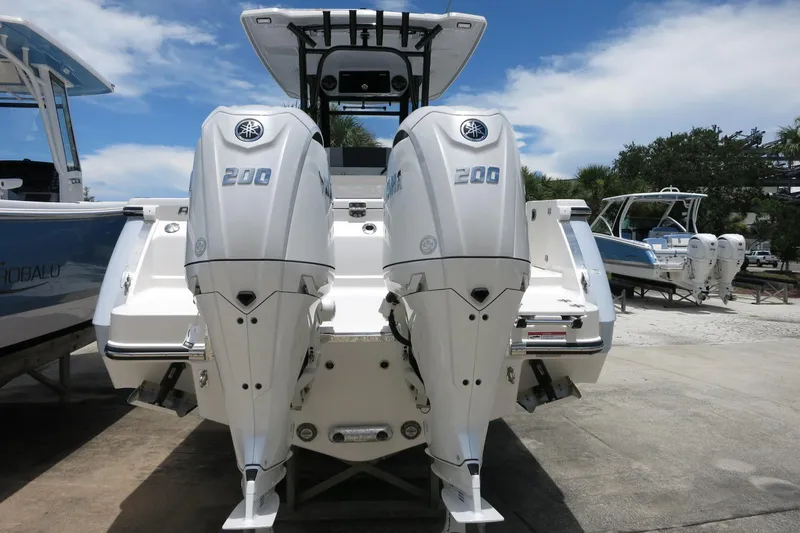 Slide: The Image of 2026 Robalo R270 Center Console with twin 200 horsepower engines, docked outdoors. - 42
