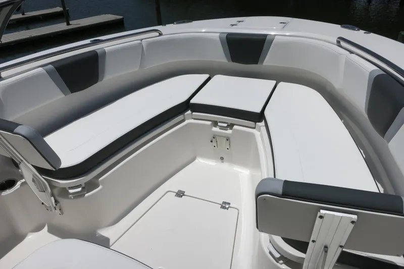 Slide: The Image of 2026 Robalo R270 Center Console boat interior with cushioned seating and storage compartments. - 22