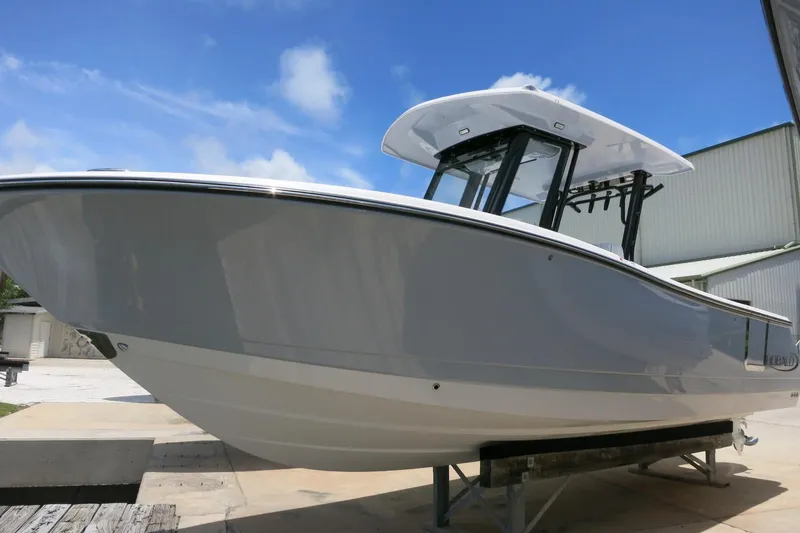 Slide: The Image of 2026 Robalo R270 Center Console boat displayed outdoors under a clear blue sky. - 5