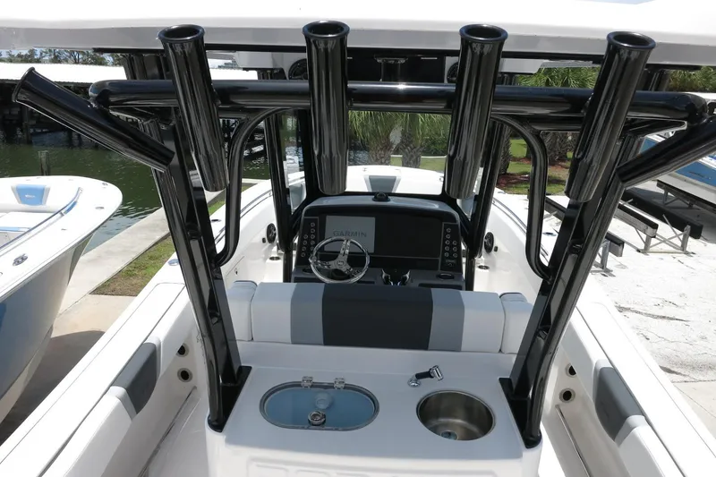 Slide: The Image of 2026 Robalo R270 Center Console boat interior with rod holders and navigation system. - 45