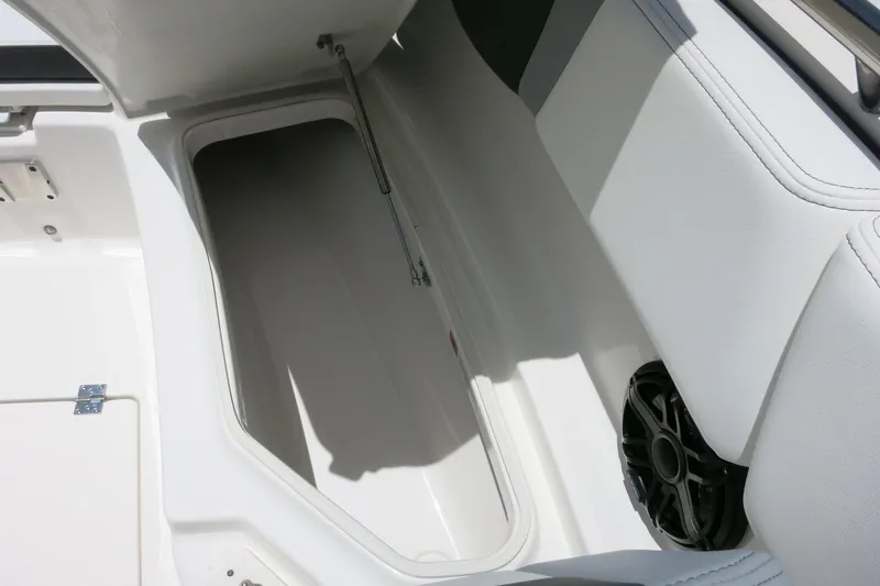 Slide: The Image of 2026 Robalo R270 Center Console storage compartment with speaker, showcasing sleek design and functionality. - 24