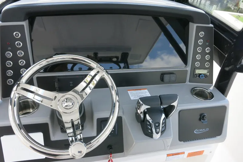 Slide: The Image of 2026 Robalo R270 Center Console dashboard with steering wheel and control panel. - 32