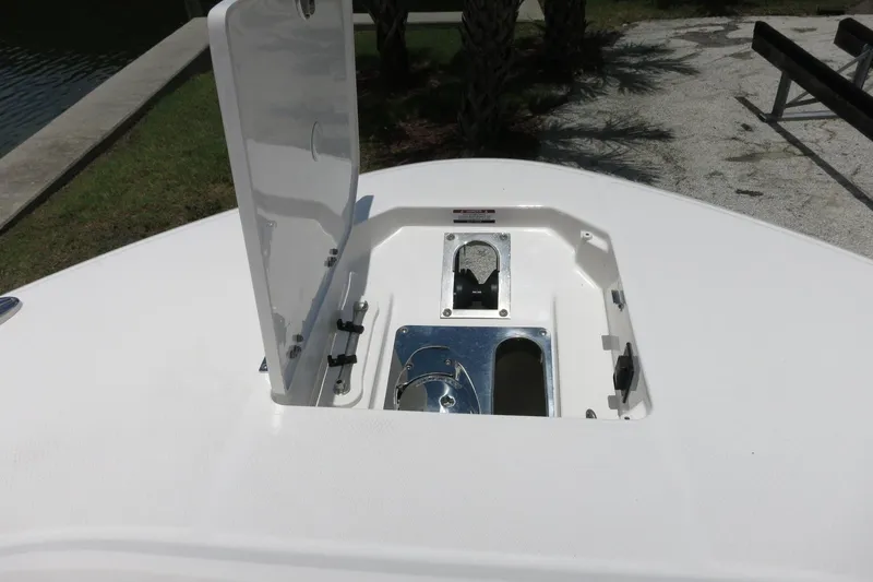 Slide: The Image of Open hatch on 2026 Robalo R270 Center Console boat, showcasing storage compartment. - 61