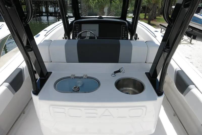 Slide: The Image of 2026 Robalo R270 Center Console boat interior with seating, sink, and storage. - 46