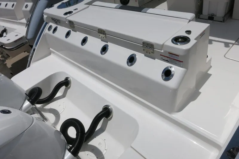 Slide: The Image of 2026 Robalo R270 Center Console boat deck with engine connections and storage compartments. - 9