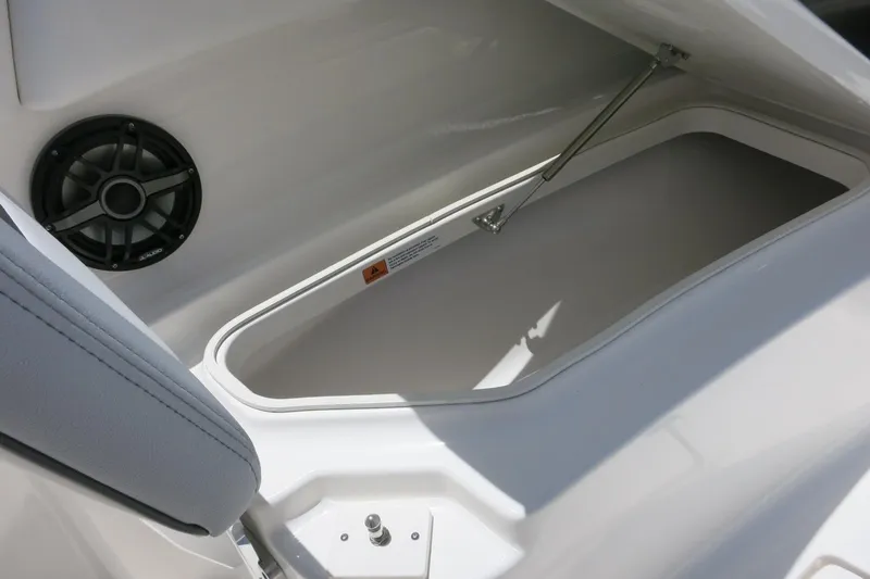 Slide: The Image of 2026 Robalo R270 Center Console storage compartment with speaker detail. - 25