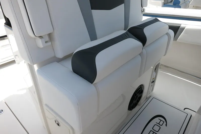 Slide: The Image of 2026 Robalo R270 Center Console boat interior with cushioned seating and storage. - 57