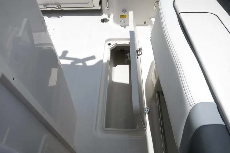 Slide: The Image of 2026 Robalo R270 Center Console boat storage compartment with open hatch. - 68