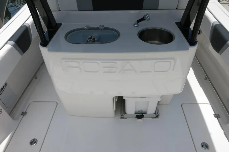 Slide: The Image of 2026 Robalo R270 Center Console boat interior with sink and storage compartments. - 47