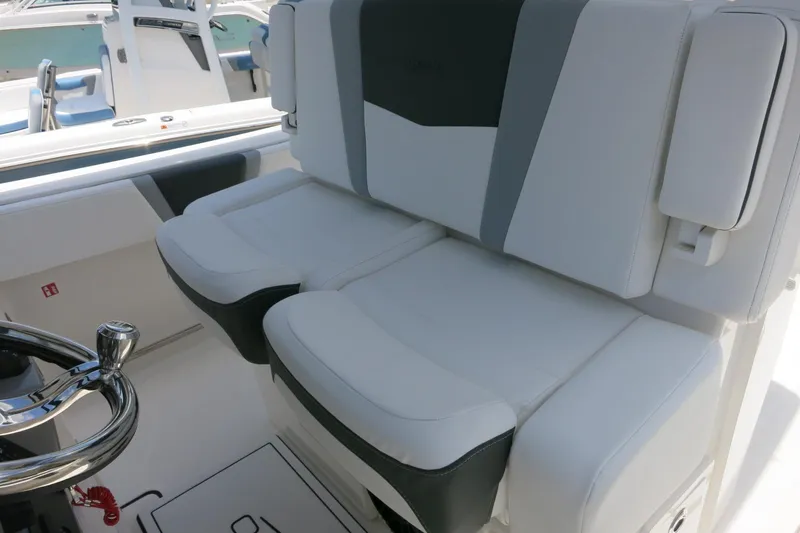 Slide: The Image of 2026 Robalo R270 Center Console boat interior with plush seating and sleek steering wheel. - 31
