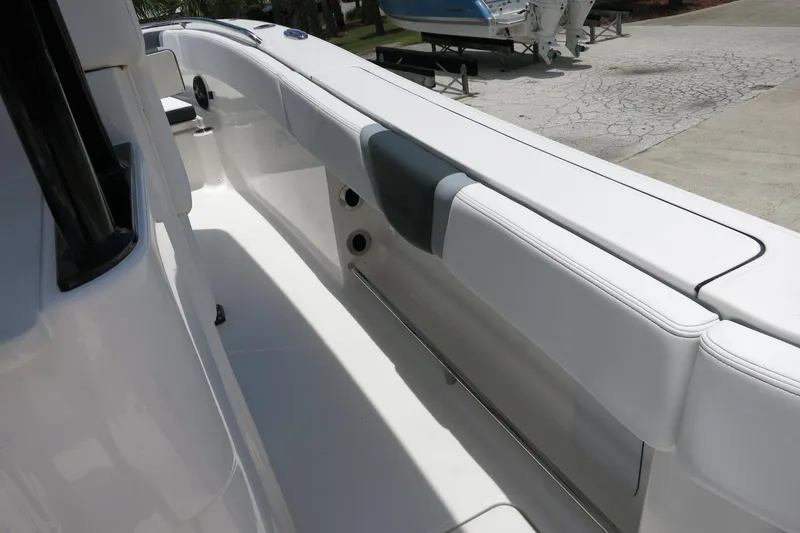 Slide: The Image of 2026 Robalo R270 Center Console boat interior with sleek white seating and modern design. - 52