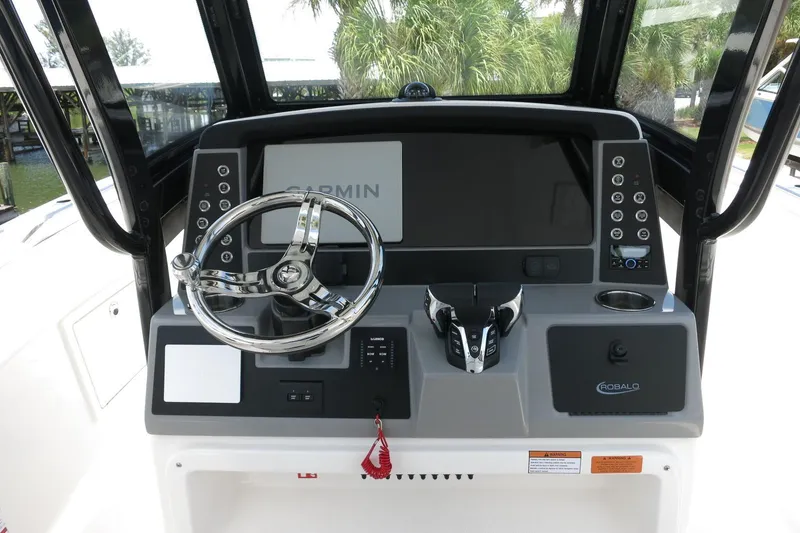 Slide: The Image of 2026 Robalo R270 Center Console helm with Garmin display and modern controls. - 51