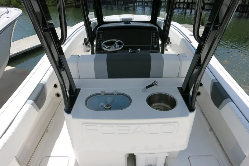 Slide: The Image of 2026 Robalo R270 Center Console boat interior with helm and seating area. - 12