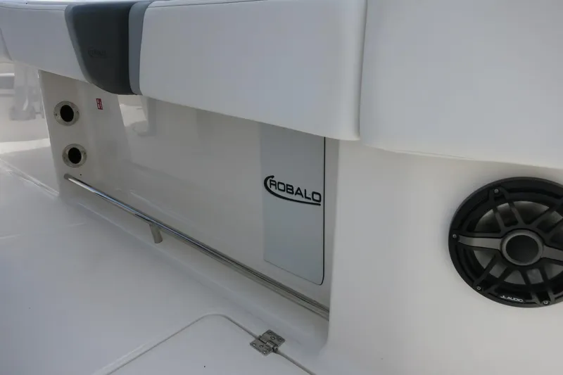 Slide: The Image of 2026 Robalo R270 Center Console boat interior with speaker and branding. - 34