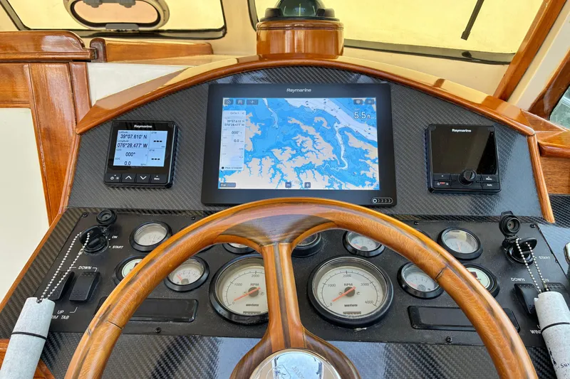 Slide: The Image of Helm of 2005 Marlow 375 yacht with navigation instruments and wooden steering wheel. - 23