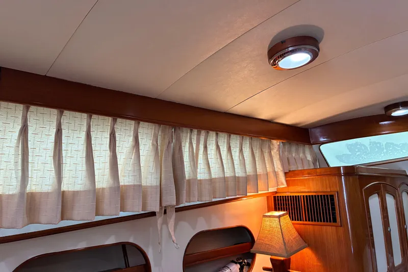Slide: The Image of Interior of a 2005 Marlow 375 yacht with elegant wood paneling and soft lighting. - 40