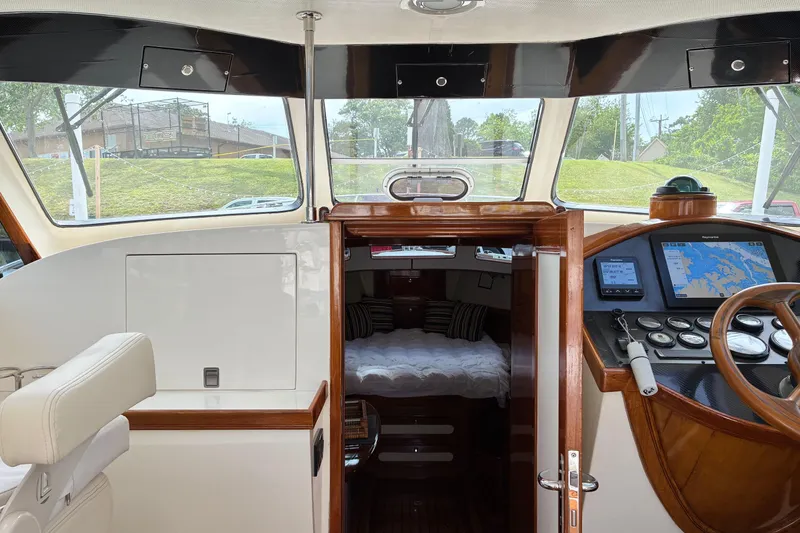 Slide: The Image of Interior view of a 2005 Marlow 375 yacht, featuring helm and cabin entrance. - 18