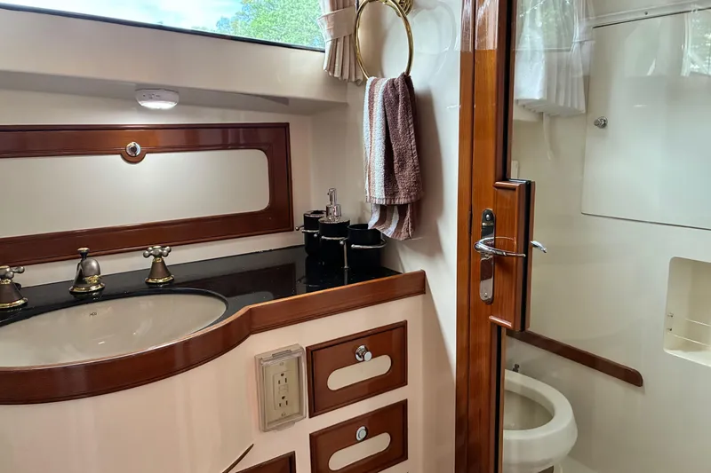 Slide: The Image of Luxurious Marlow 375 yacht bathroom with elegant wood accents and modern fixtures, 2005 model. - 35