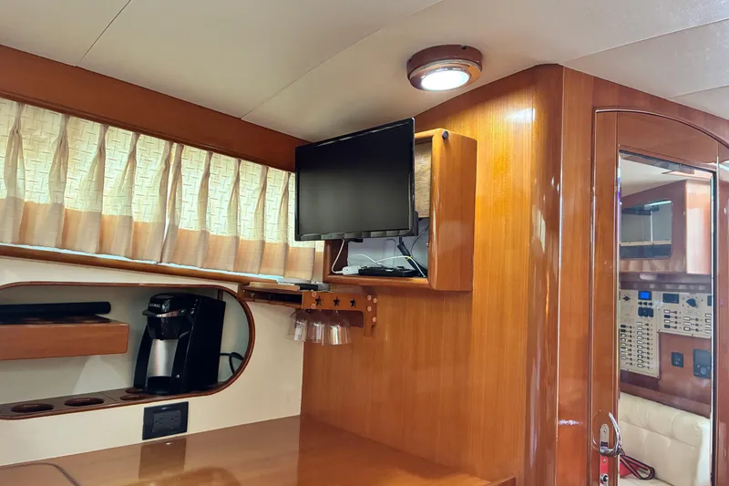 Slide: The Image of Interior of 2005 Marlow 375 yacht with TV, coffee maker, and wood paneling. - 39