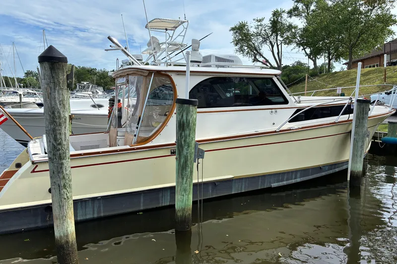 Slide: The Image of 2005 Marlow 375 yacht docked at marina, surrounded by other boats and calm water. - 1