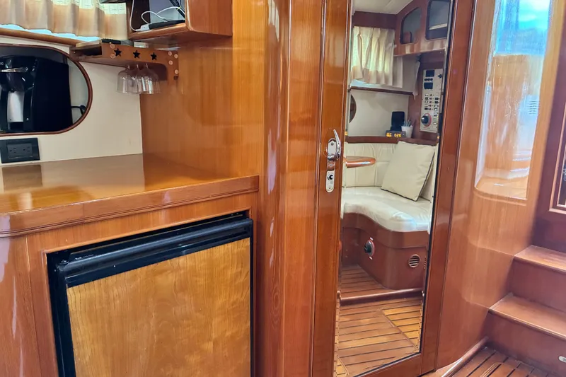 Slide: The Image of Interior of a 2005 Marlow 375 yacht with wooden cabinetry and seating area. - 33
