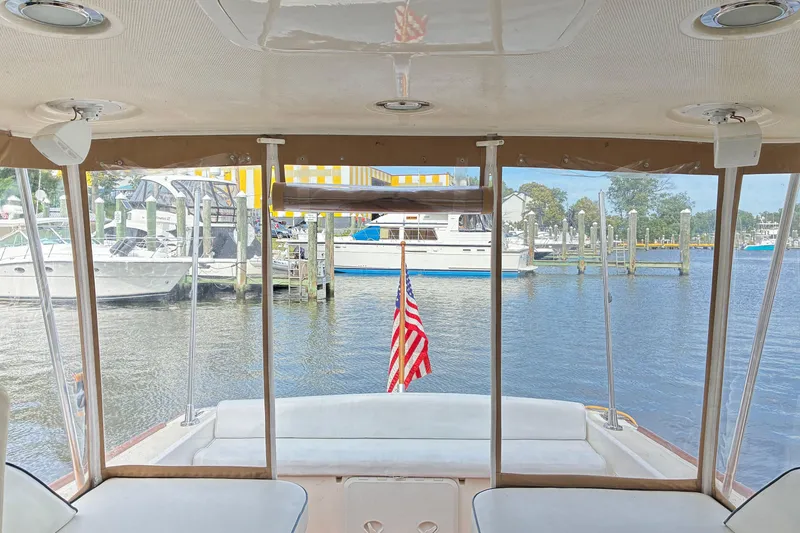 Slide: The Image of View from a 2005 Marlow 375 yacht, featuring a marina and American flag. - 15