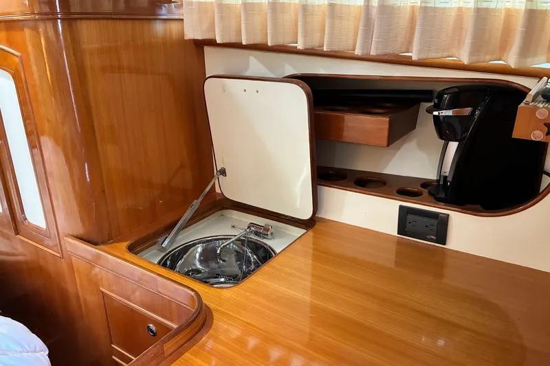 Slide: The Image of Wooden interior of a 2005 Marlow 375 yacht with sink and coffee maker. - 32