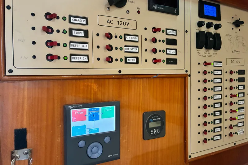 Slide: The Image of Electrical control panel on a 2005 Marlow 375 boat, featuring AC and DC switches. - 43