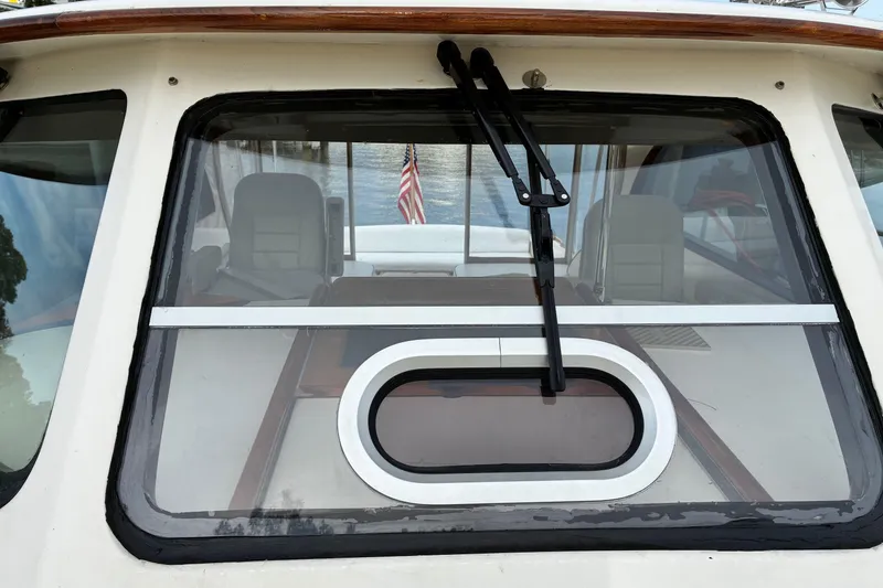 Slide: The Image of 2005 Marlow 375 boat with rear window view and American flag. - 10