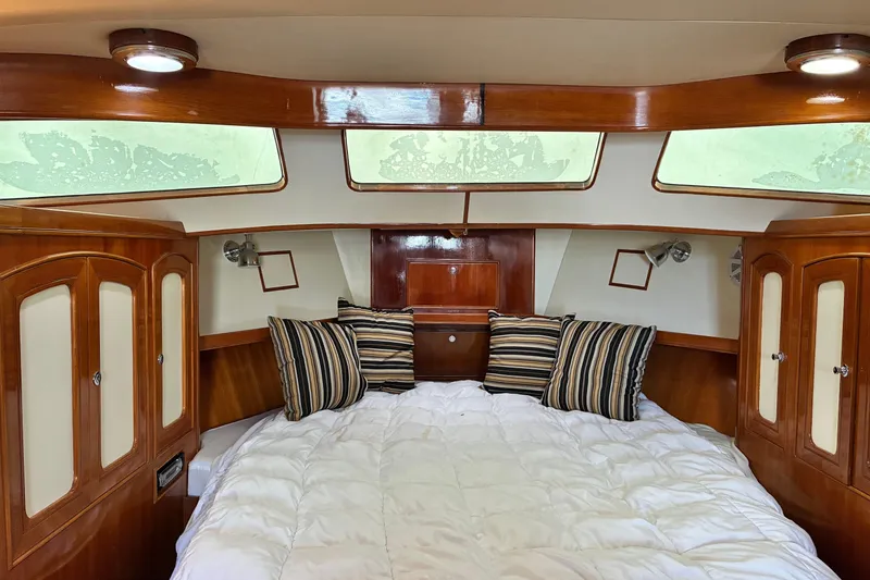 Slide: The Image of Luxurious cabin interior of 2005 Marlow 375 yacht with cozy bedding and wooden cabinetry. - 26