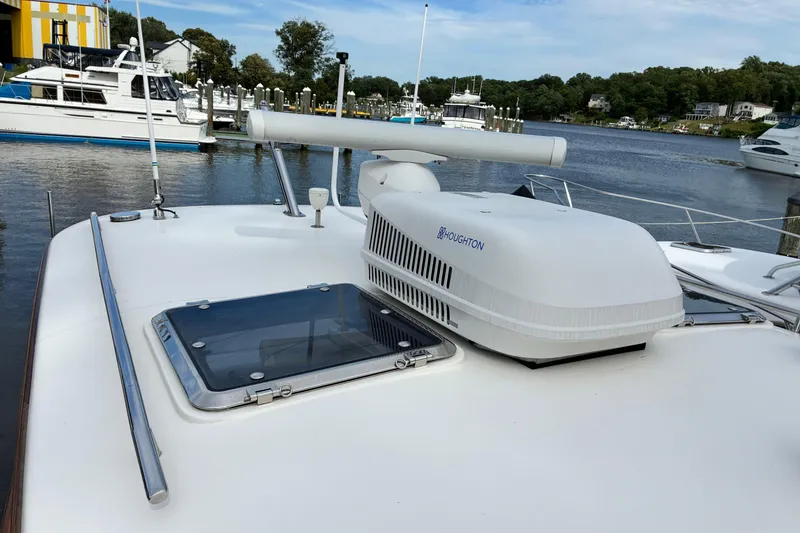 Slide: The Image of 2005 Marlow 375 yacht with rooftop equipment docked at a marina. - 9