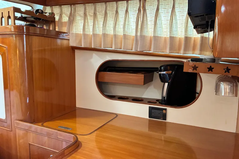 Slide: The Image of Wooden interior of a 2005 Marlow 375 yacht with coffee maker and storage. - 46