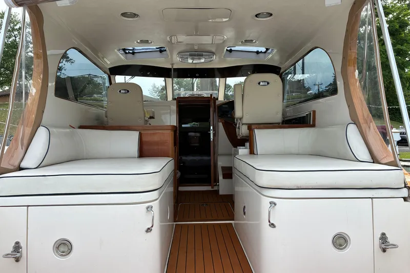 Slide: The Image of Interior of a 2005 Marlow 375 with white seating and wooden flooring. - 13