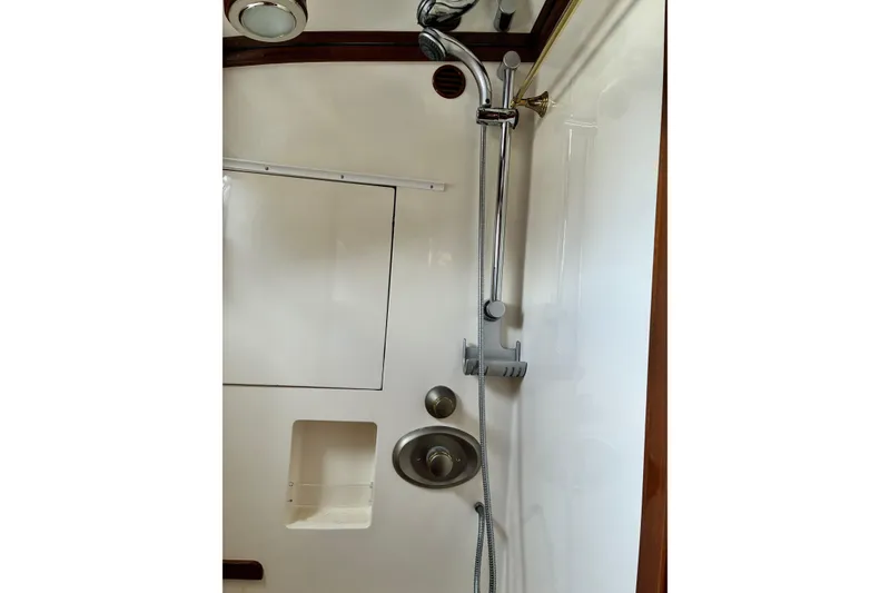 Slide: The Image of Shower area in 2005 Marlow 375 yacht, featuring chrome fixtures and white walls. - 38