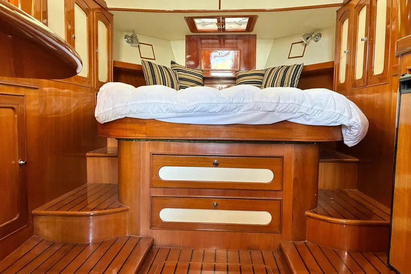 Slide: The Image of Luxurious 2005 Marlow 375 yacht interior with wooden cabinetry and cozy bed. - 25
