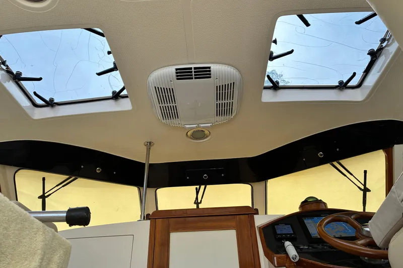 Slide: The Image of Interior view of a 2005 Marlow 375 boat cockpit with skylights and navigation equipment. - 20