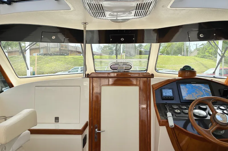 Slide: The Image of Interior view of 2005 Marlow 375 yacht helm with navigation equipment and wooden accents. - 19