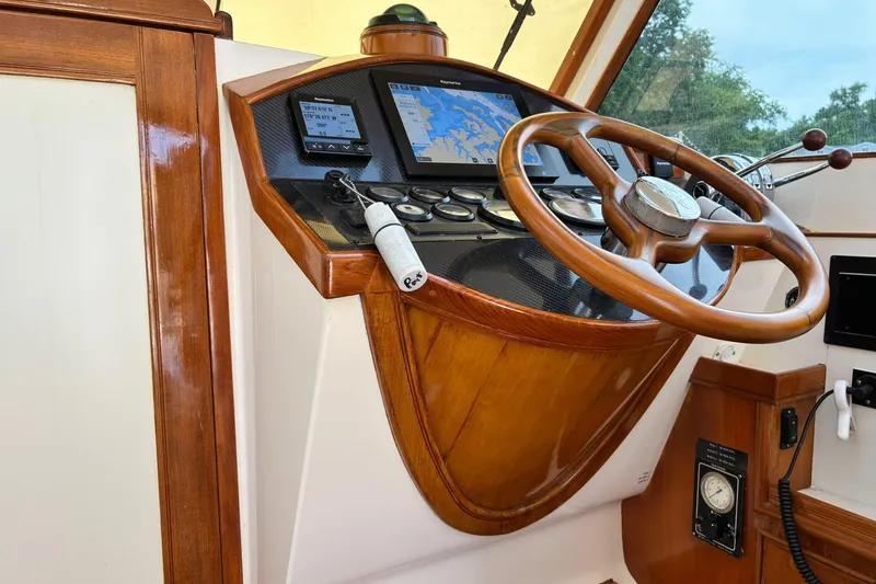 Slide: The Image of Steering wheel and dashboard of a 2005 Marlow 375 boat with navigation screens. - 21