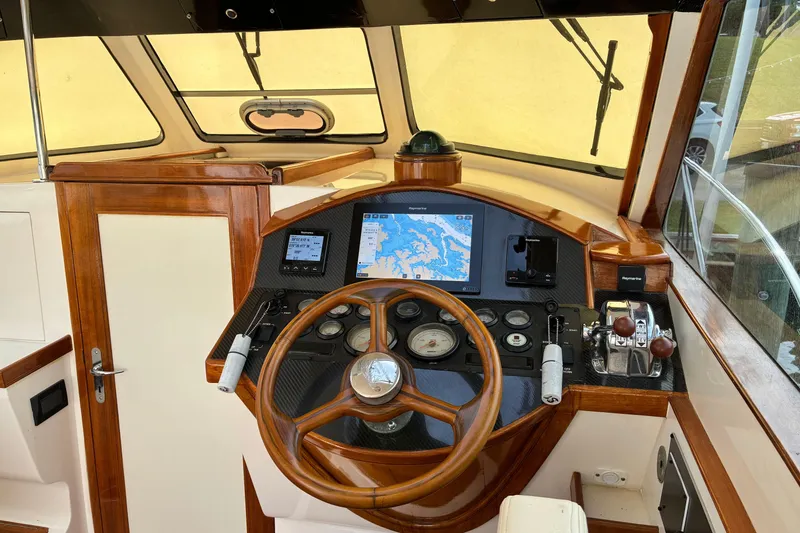 Slide: The Image of Helm of 2005 Marlow 375 boat with wooden steering wheel and navigation instruments. - 22