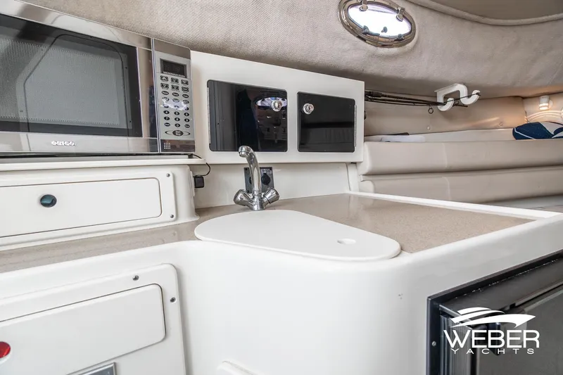 Slide: The Image of 2004 Hydra-Sports Vector 2800 WA cabin interior with kitchenette, microwave, and sink. - 17