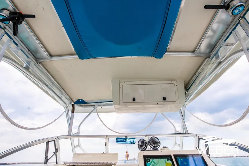 Slide: The Image of 2004 Hydra-Sports Vector 2800 WA boat interior with blue canopy and navigation equipment. - 20