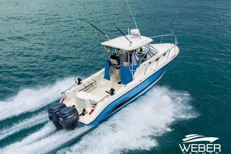 Slide: The Image of 2004 Hydra-Sports Vector 2800 WA cruising on open water, featuring dual Yamaha engines. - 2