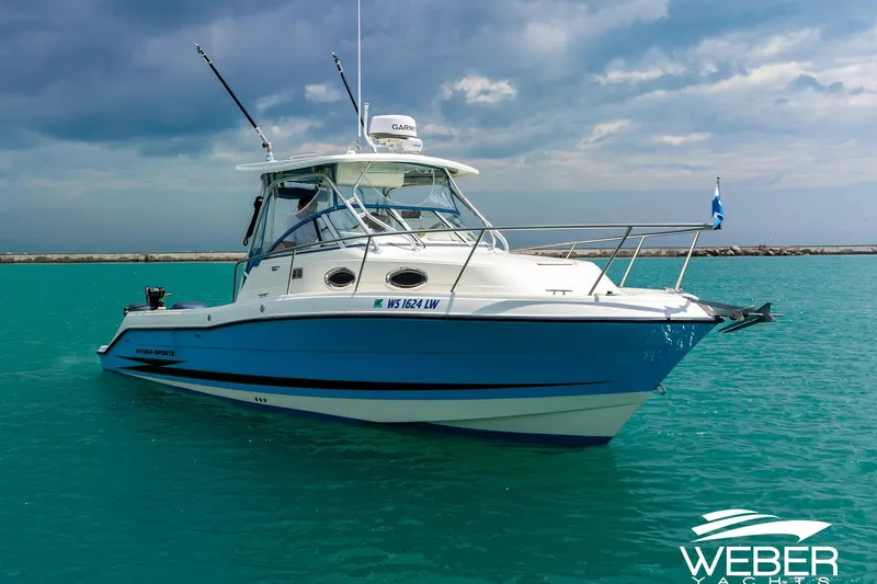 Slide: The Image of 2004 Hydra-Sports Vector 2800 WA boat on turquoise water under cloudy sky. - 26