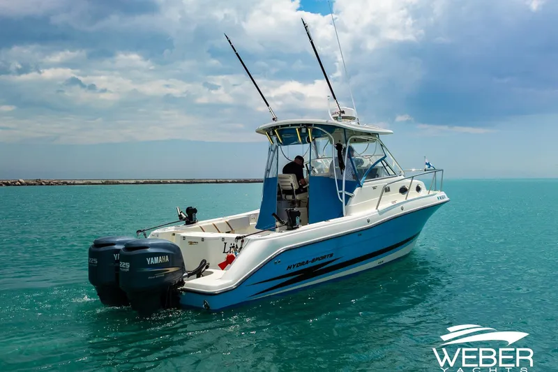 Slide: The Image of 2004 Hydra-Sports Vector 2800 WA boat on turquoise water, featuring twin Yamaha engines. - 28