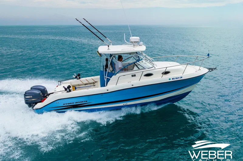Slide: The Image of 2004 Hydra-Sports Vector 2800 WA cruising on open water, featuring dual Yamaha engines. - 0