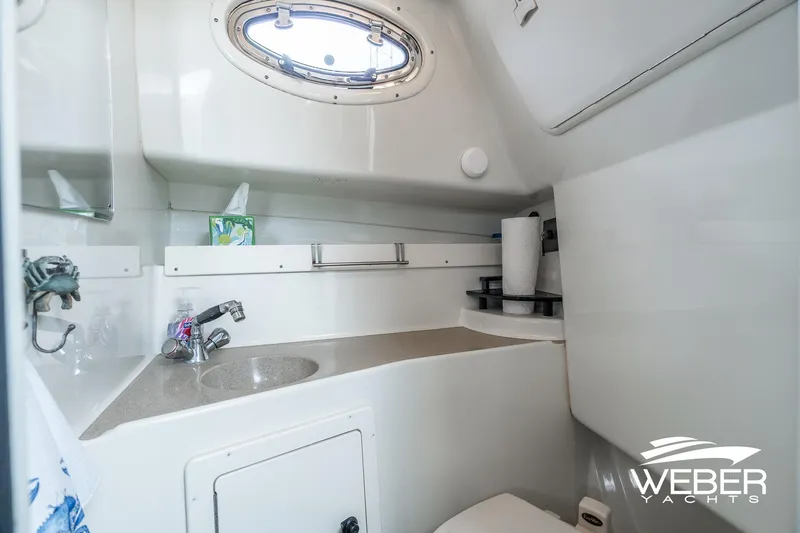 Slide: The Image of 2004 Hydra-Sports Vector 2800 WA boat bathroom with sink, mirror, and storage. - 18